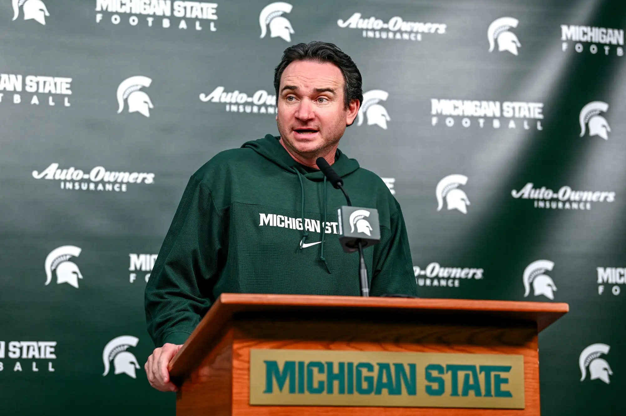 Michigan State coach Jonathan Smith talks the media on the first national signing day for college football recruits.