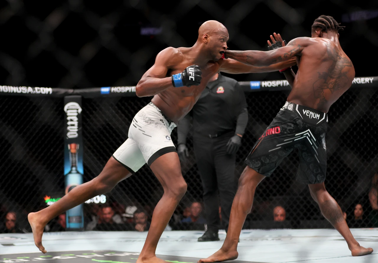 Miami, Florida, USA; Michael Page (blue gloves) fights Kevin Holland (red gloves) during UFC 299 at Kayesa Center. 