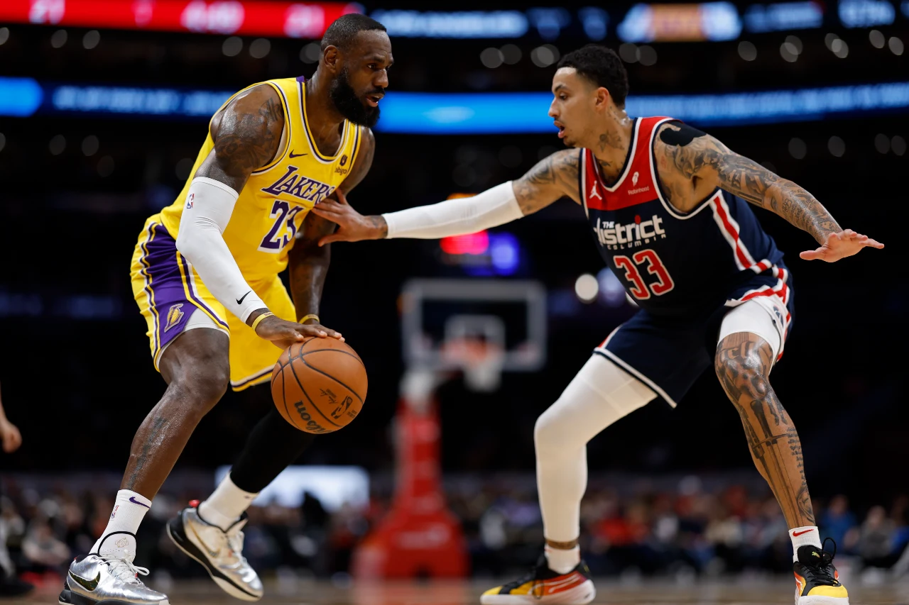 Washington, District of Columbia, USA; Los Angeles Lakers forward LeBron James (23) drives to the basket as Washington Wizards forward Kyle Kuzma (33) defends in the first half at Capital One Arena.