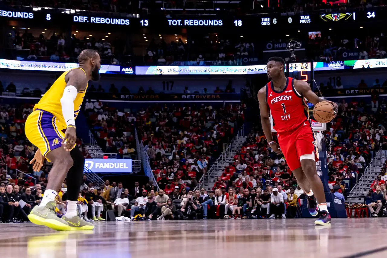 New Orleans Pelicans forward Zion Williamson (1) dribbles against Los Angeles Lakers forward LeBron James (23) during the first half of a play-in game of the 2024 NBA playoffs against the New Orleans Pelicans at Smoothie King Center.