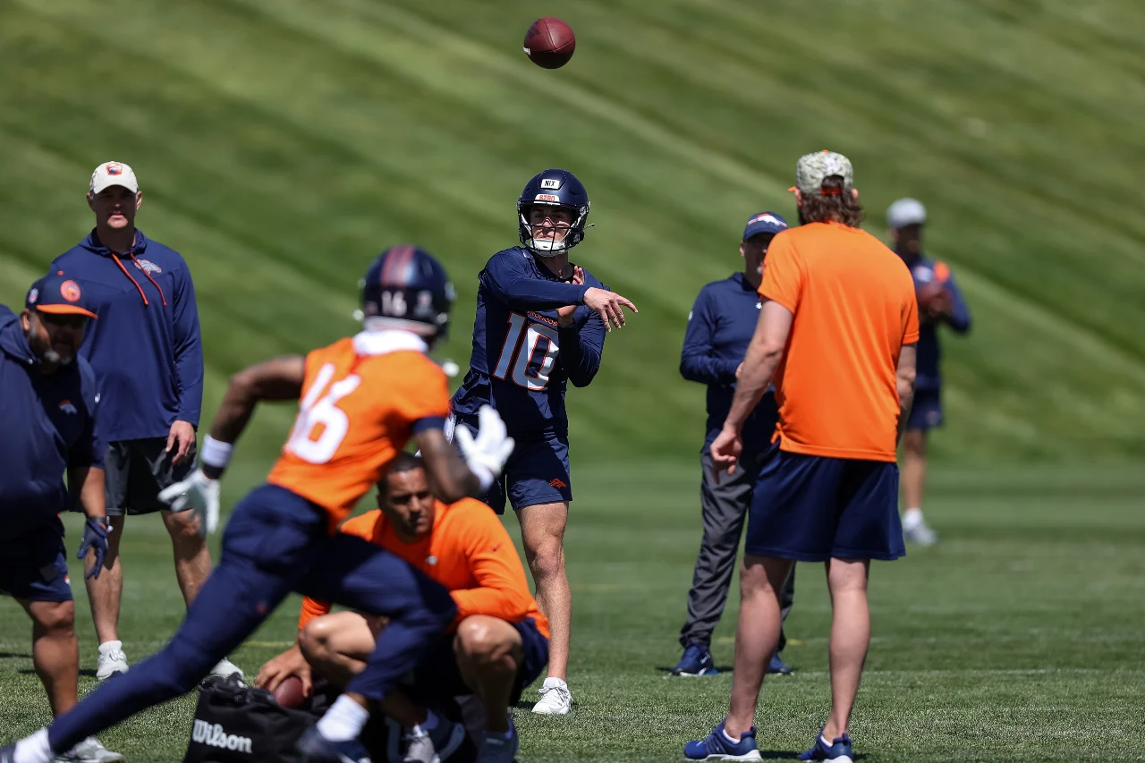 Denver Broncos quarterback Bo Nix (10) passes to wide receiver Troy Franklin (16) during organized team activities at Centura Health Training Center.