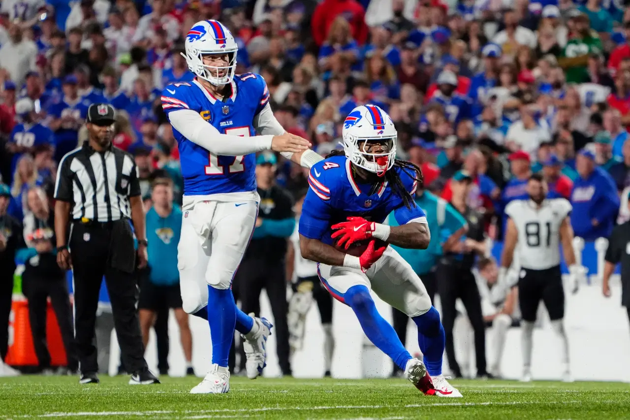 Buffalo Bills quarterback Josh Allen (17) hands off to running back James Cook (4) during the second half against the Jacksonville Jaguars at Highmark Stadium