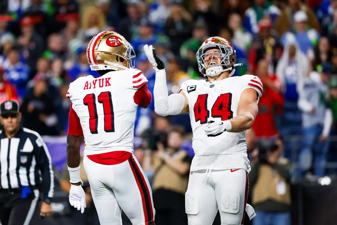 San Francisco 49ers fullback Kyle Juszczyk (44) celebrates with wide receiver Brandon Aiyuk (11) after rushing for a touchdown against the Seattle Seahawks at Lumen Field.