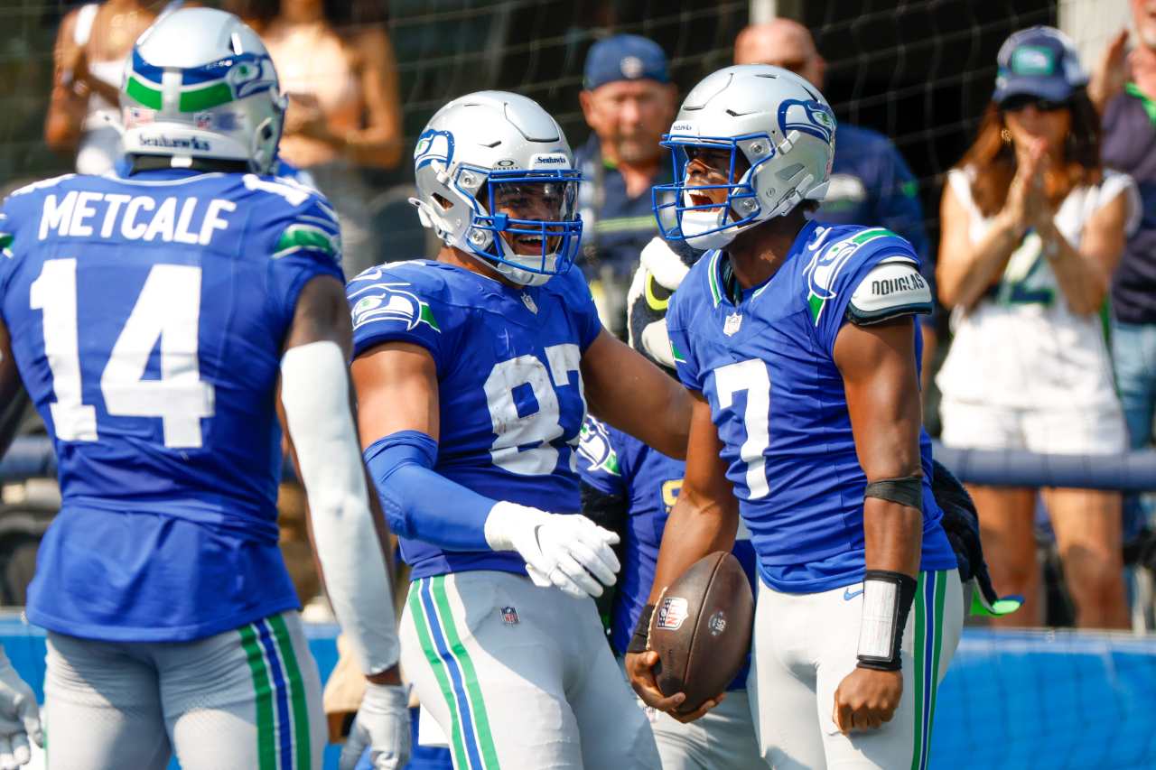 Seattle Seahawks quarterback Geno Smith (7) celebrates with tight end Noah Fant (87) after rushing for a touchdown against the Denver Broncos during the second quarter at Lumen Field.