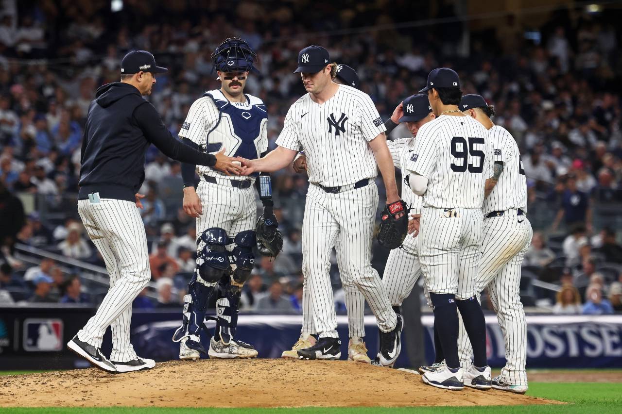 New York Yankees manager Aaron Boone (17) relieves New York Yankees pitcher Gerrit Cole (45) during the sixth inning against the Kansas City Royals during game one of the ALDS for the 2024 MLB Playoffs at Yankee Stadium.