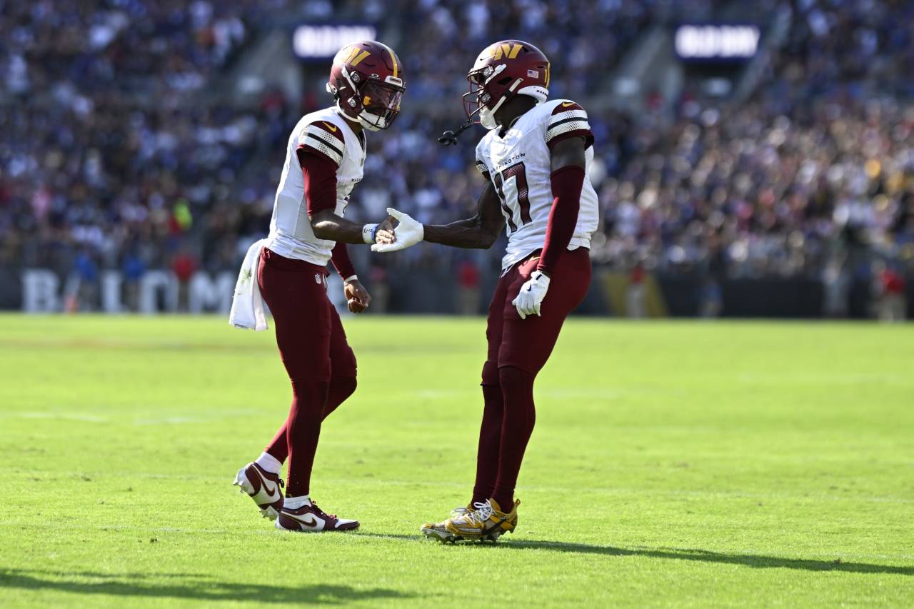 Washington Commanders quarterback Jayden Daniels (5) celebrates with Washington Commanders wide receiver Terry McLaurin (17) after catching a fourth quarter touchdown against the Baltimore Ravens at M&T Bank Stadium.