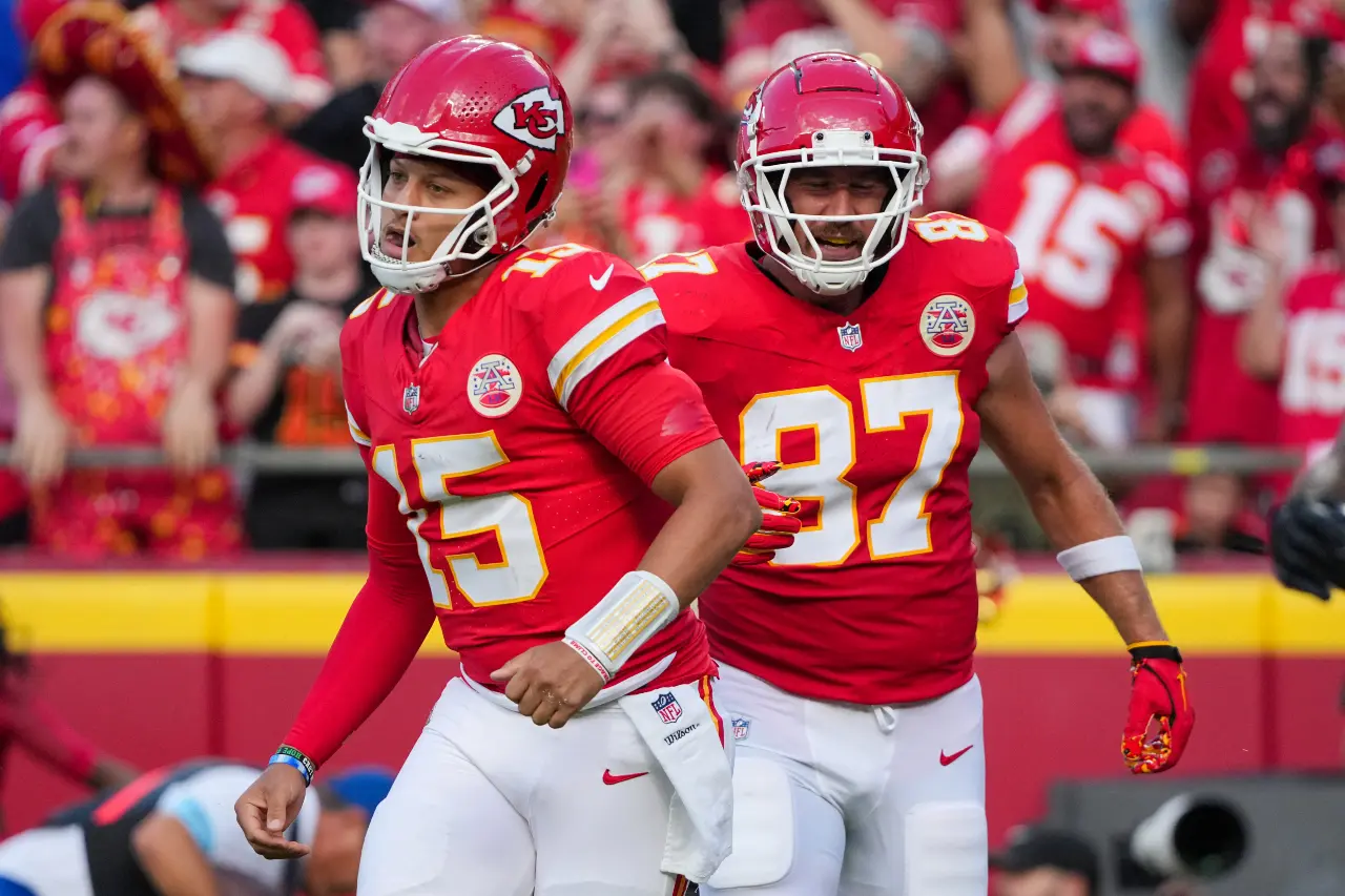 Kansas City Chiefs quarterback Patrick Mahomes (15) and tight end Travis Kelce (87) return to the sidelines after a score against the Cincinnati Bengals during the first half at GEHA Field at Arrowhead Stadium.