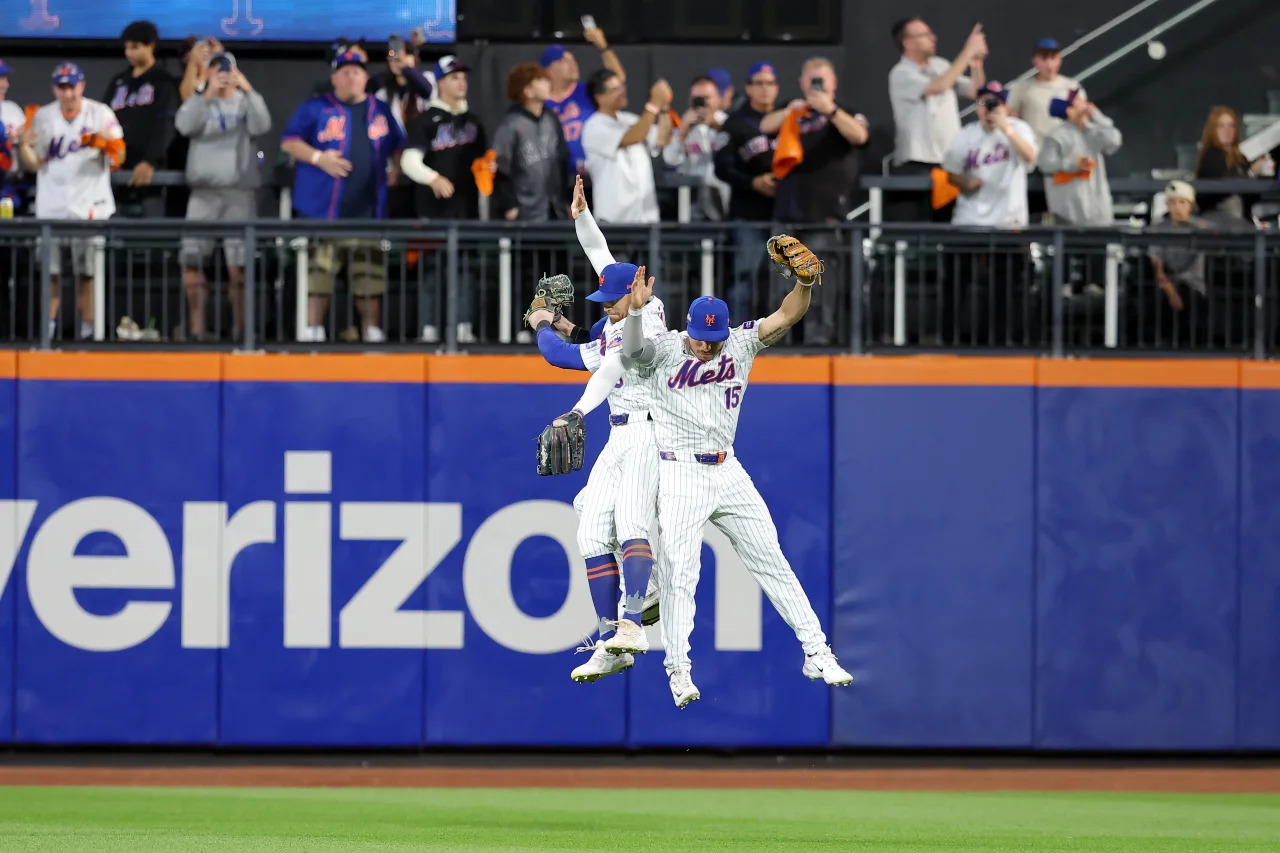 New York Mets outfielder Brandon Nimmo (9) and outfielder Harrison Bader (44) and outfielder Tyrone Taylor (15) celebrate after defeating the Philadelphia Phillies in game three of the NLDS for the 2024 MLB Playoffs at Citi Field.