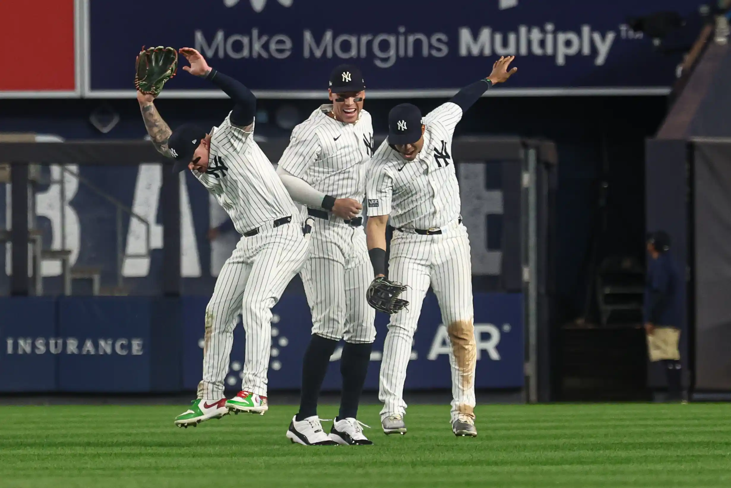 New York Yankees outfielder Alex Verdugo (24) celebrates with outfielder Aaron Judge (99) and outfielder Juan Soto (22) after defeating the Kansas City Royals in game one of the ALDS for the 2024 MLB Playoffs at Yankee Stadium.